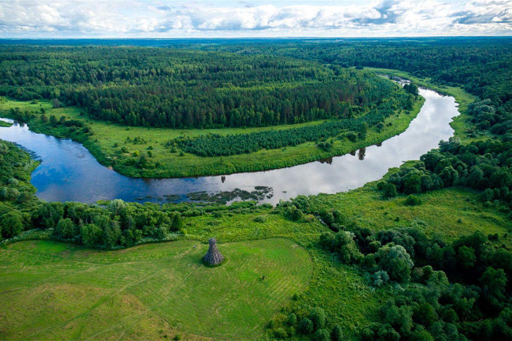 Природный ландшафт.Река изгибается в виде подковы.В далеке лес.